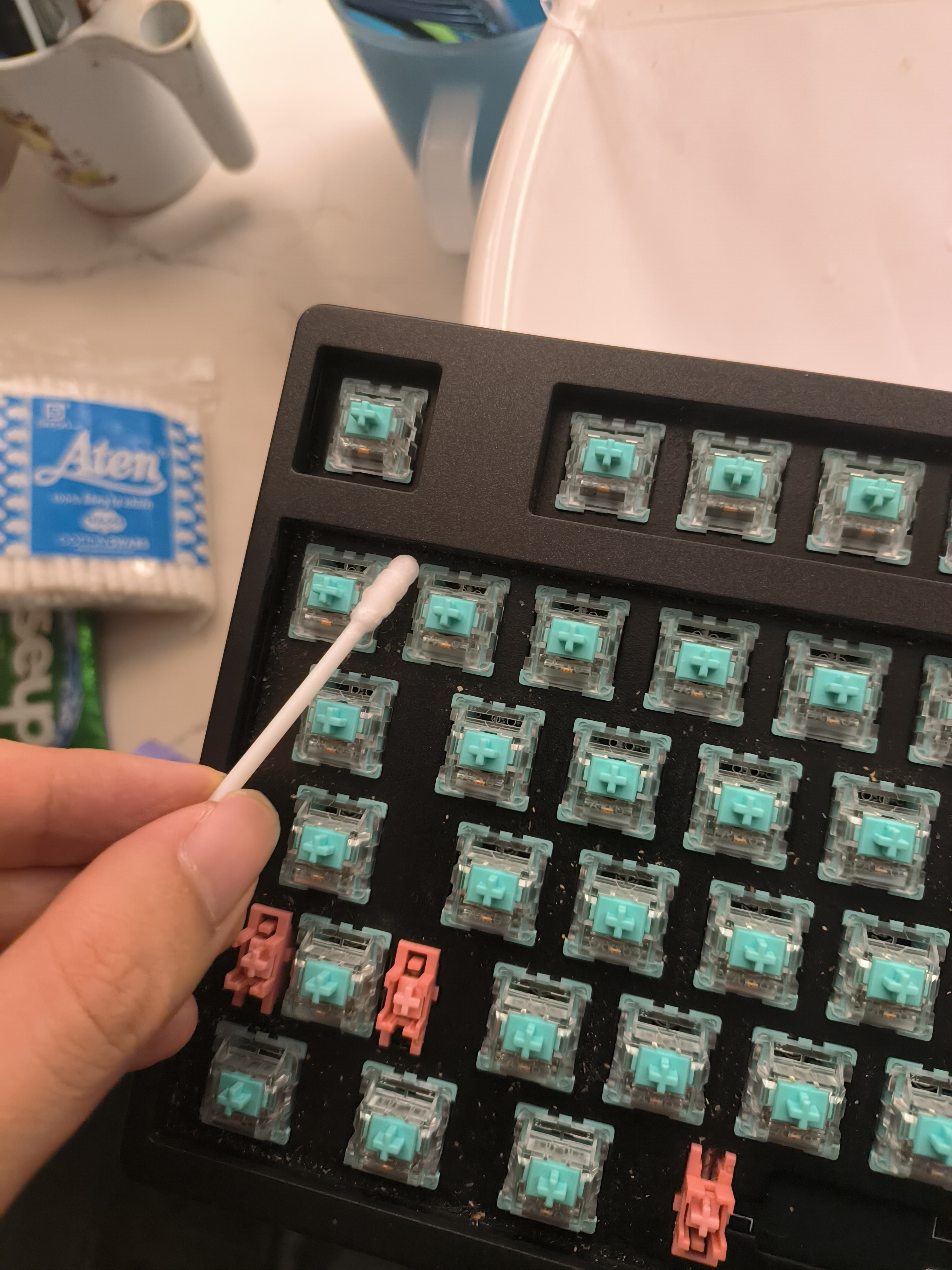 cleaning keyboard with a cotton swab